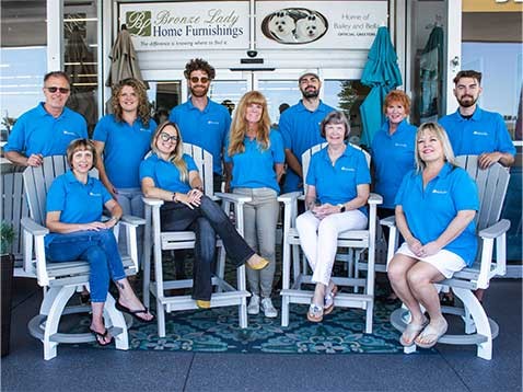 Group photo of the store staff all wearing blue polo shirts